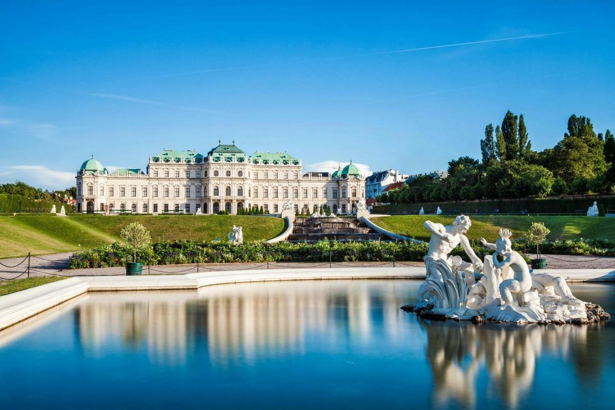 a building with a fountain in the water in front of it