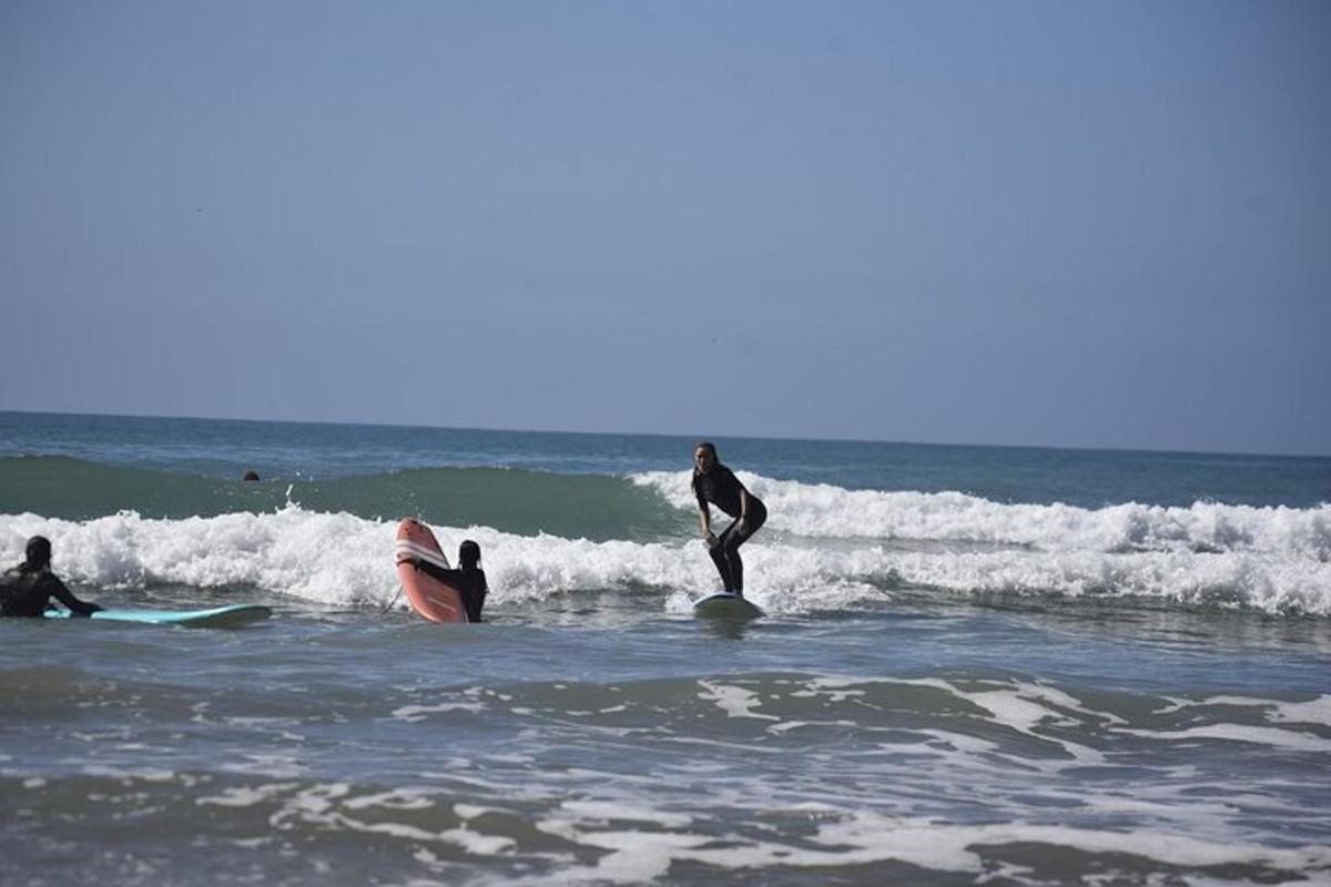 a group of people riding waves on surfboards in the ocean