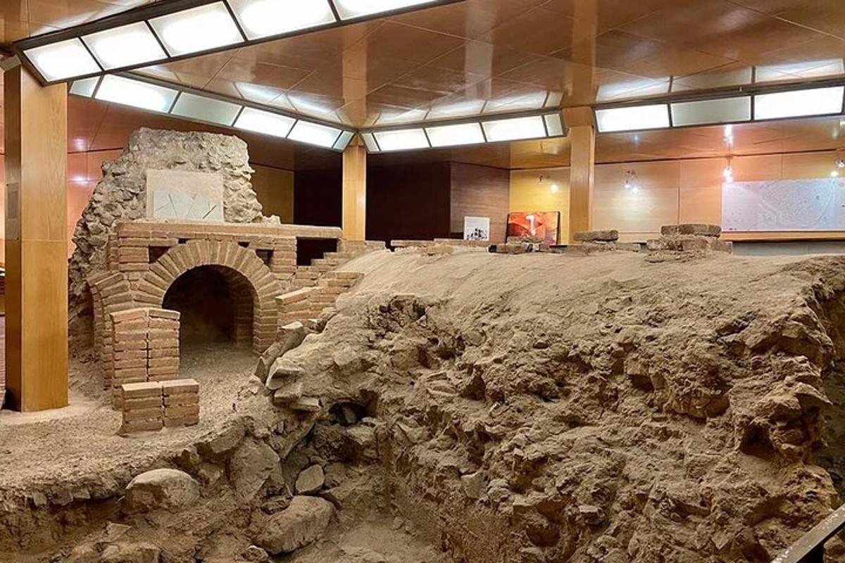 a large room with a stone oven in a museum