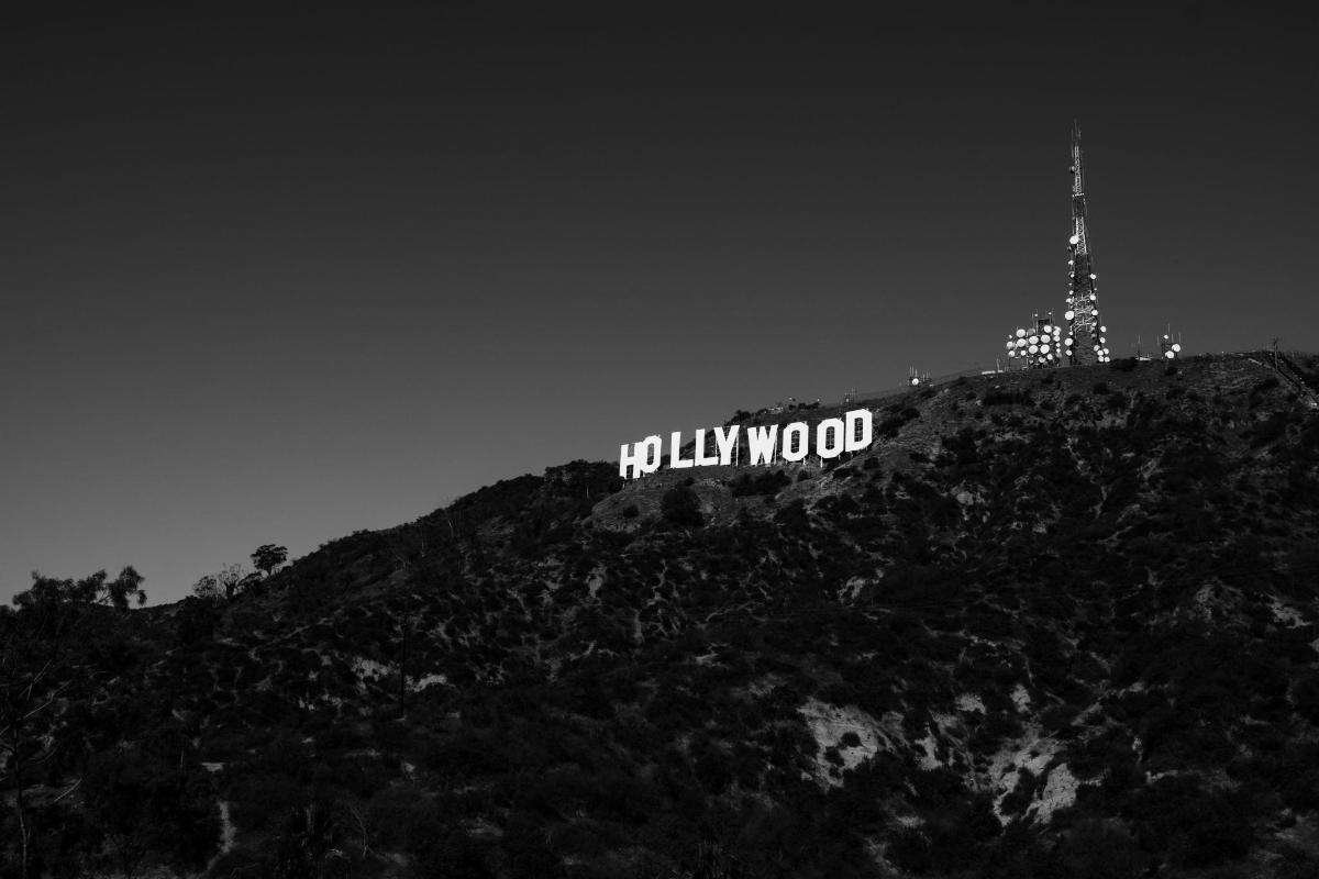 a lit up hollywood sign on top of a mountain