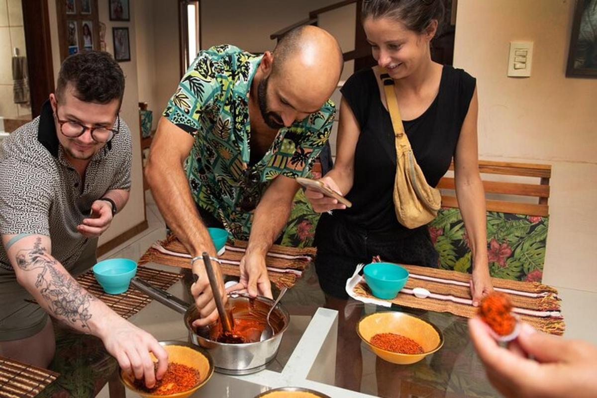 a group of people standing around a table preparing food