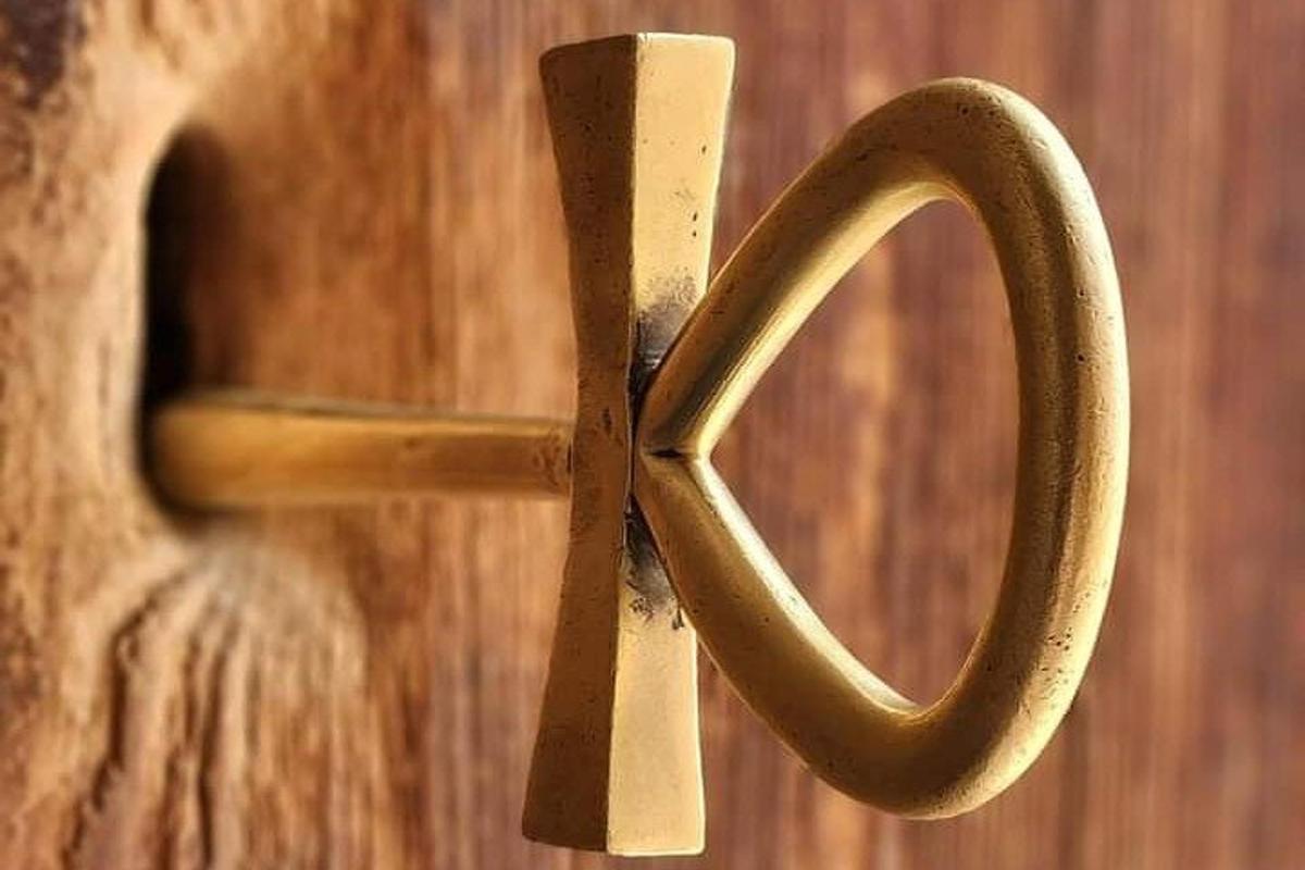 a wooden door with a metal cross on it