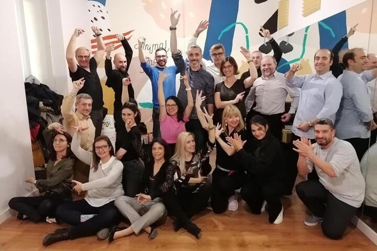 a group of people posing for a picture with their hands in the air