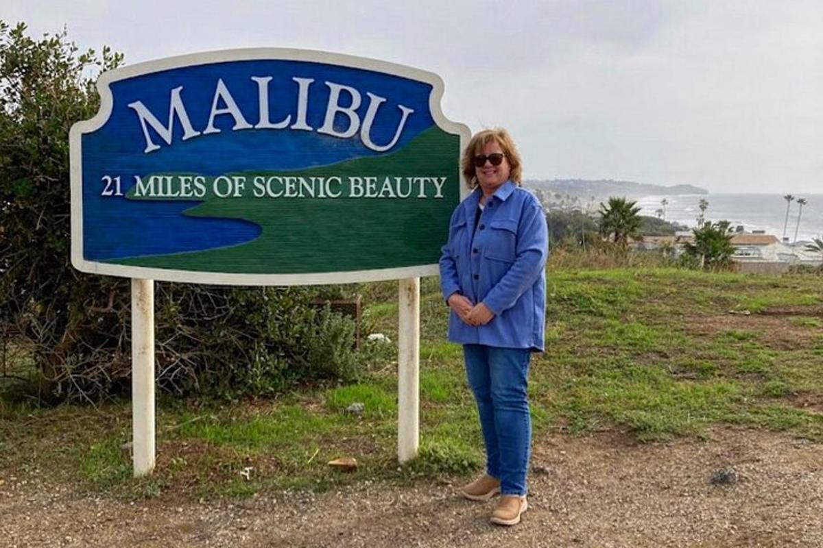 a woman standing in front of a sign