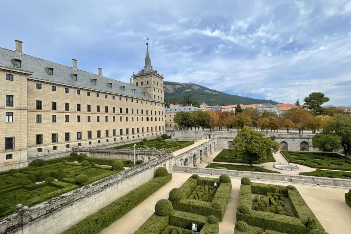 a large building with a garden in front of it
