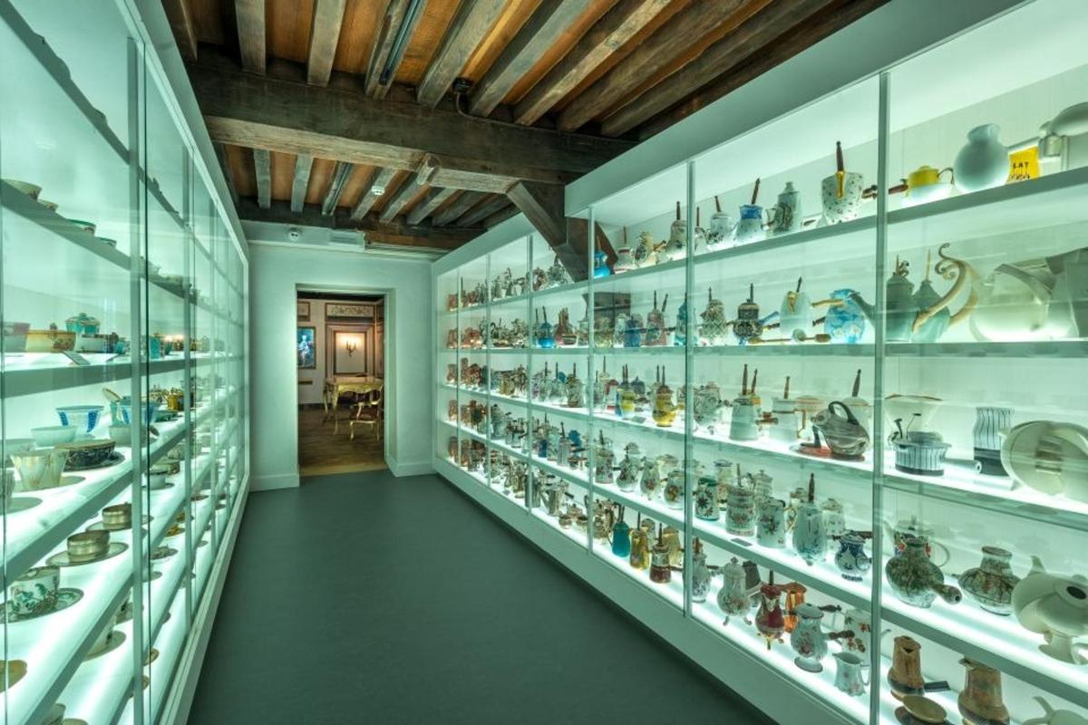 a room filled with glass shelves filled with vases
