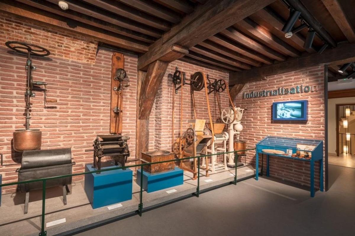 a room with a brick wall and a room with a couch