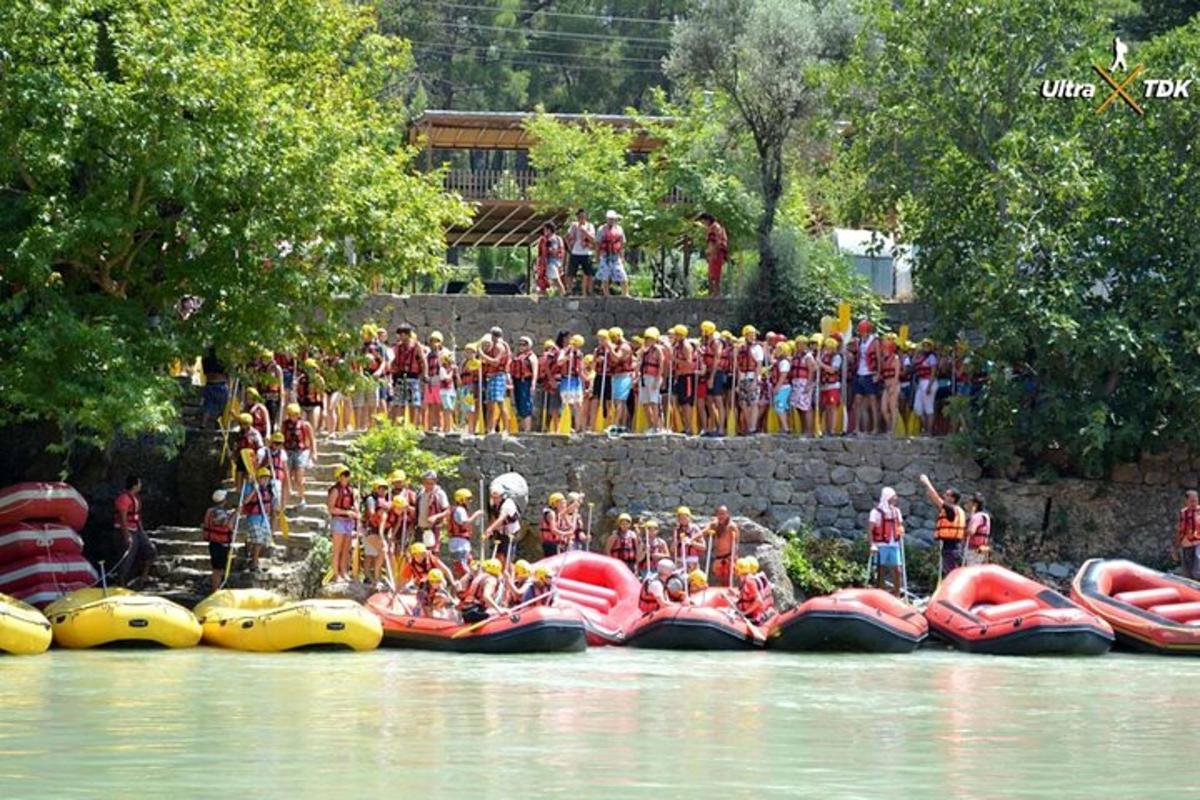 a group of people standing on rafts in the water