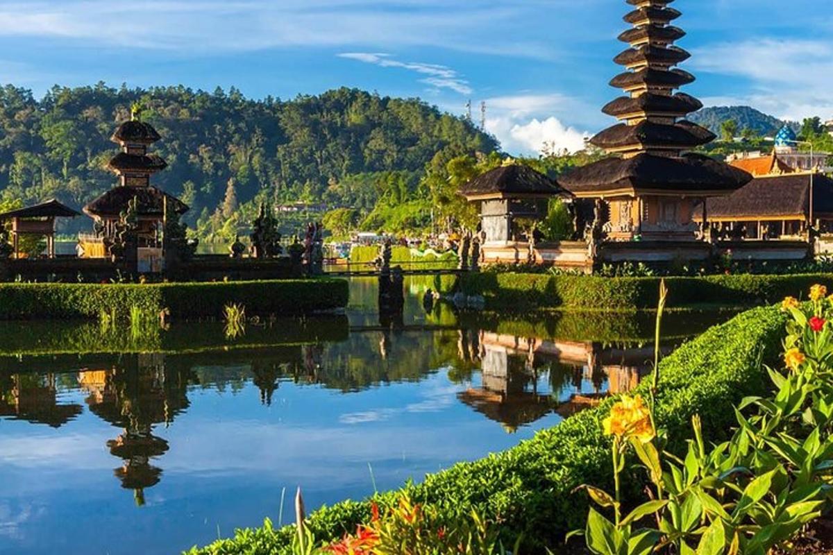a reflection of two pagodas in a body of water