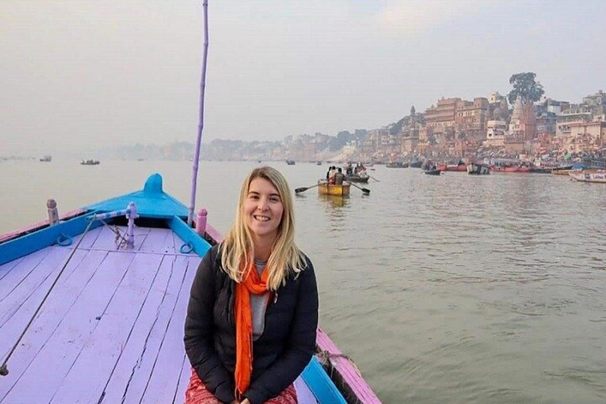 a girl sitting on a boat in the water