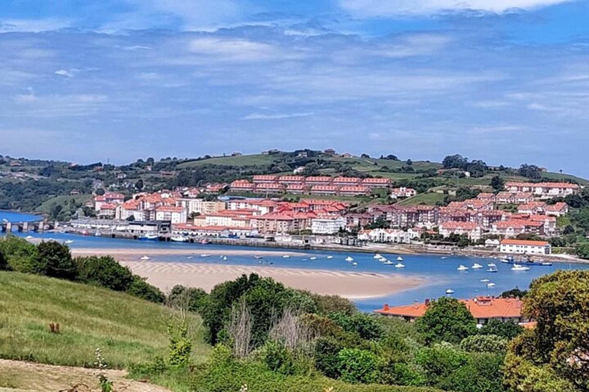 a town with a beach and boats in the water