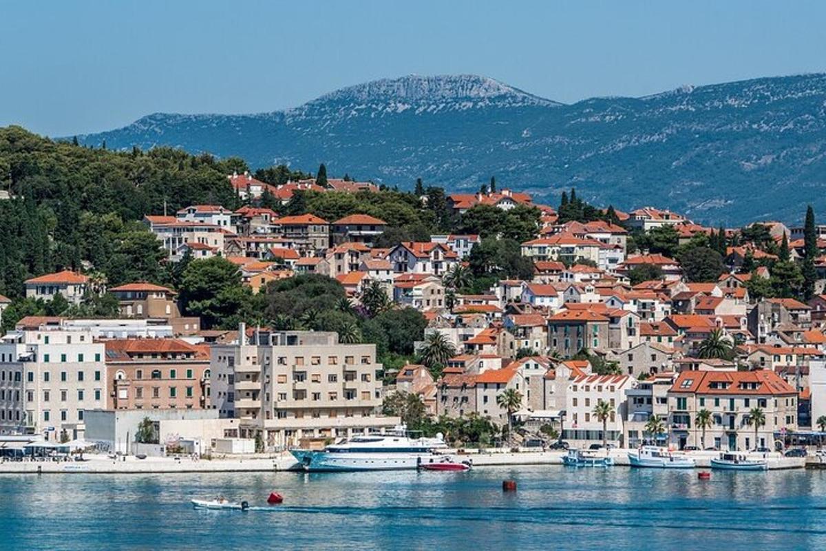 a town on a hill with boats in the water