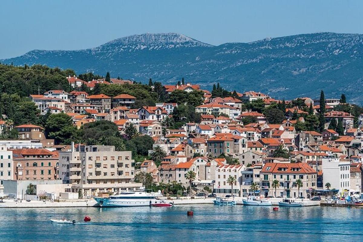 a town on a hill with boats in the water