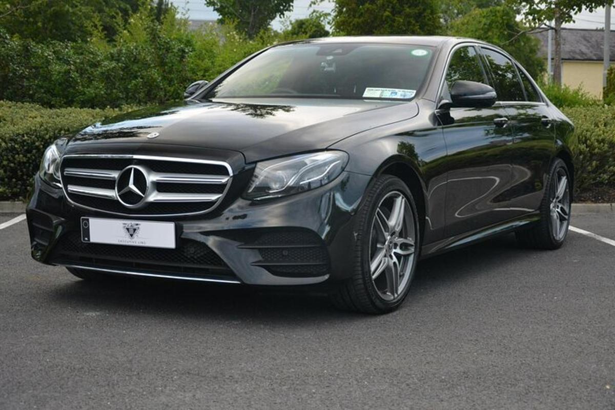a black mercedes benz car parked in a parking lot