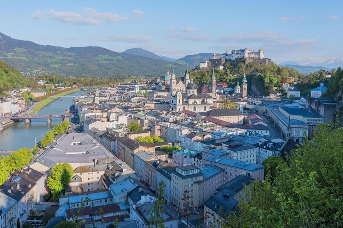 an aerial view of a city with a river and buildings