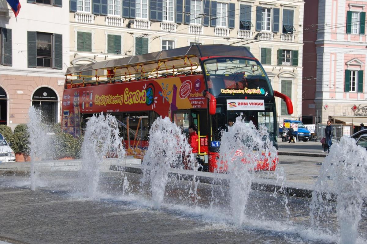 a double decker bus driving past a water fountain