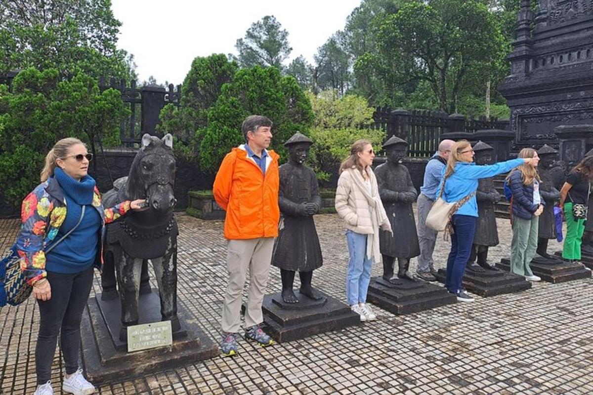 a group of people standing around a statue of a horse