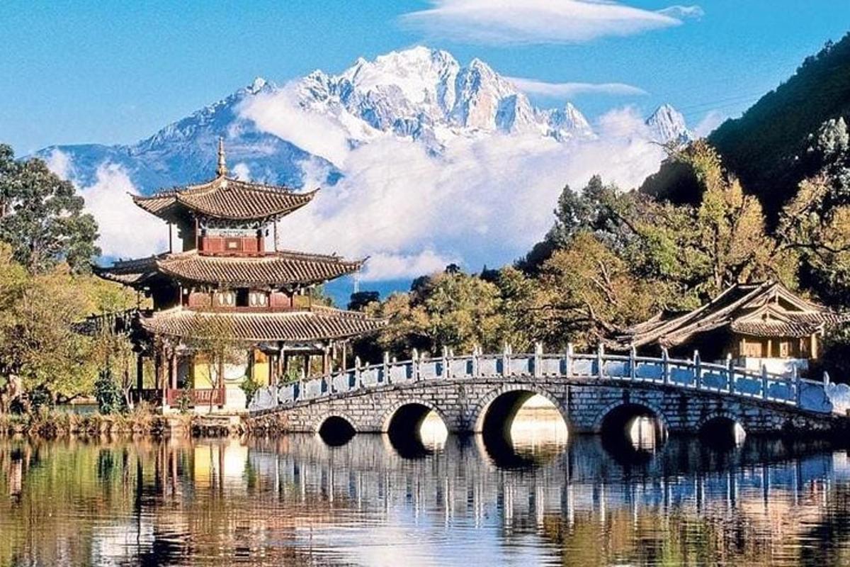 a bridge over a lake with a mountain in the background