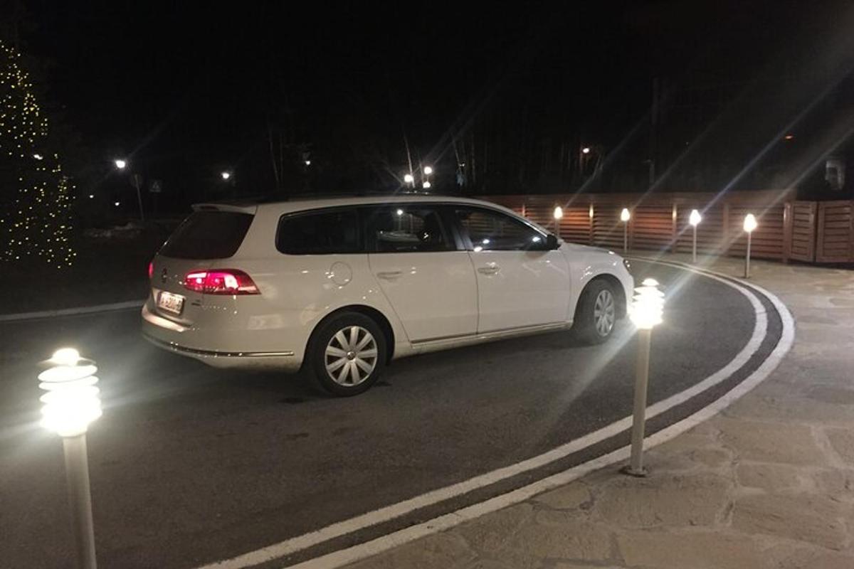 a white car parked in a parking lot at night