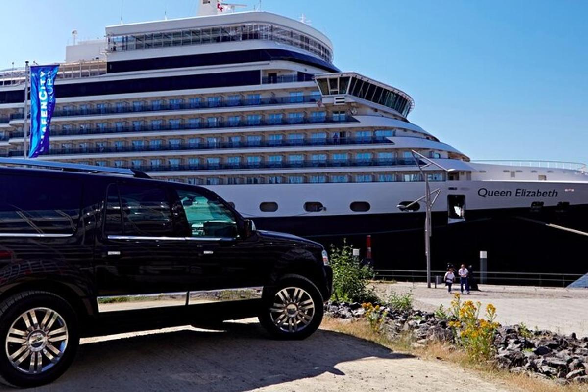 a black truck parked in front of a cruise ship