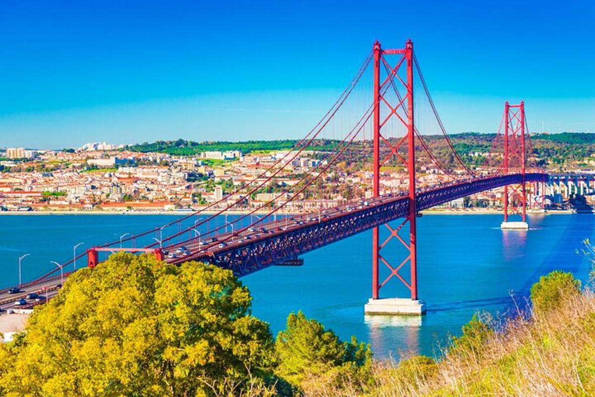 a red bridge over the water with a city