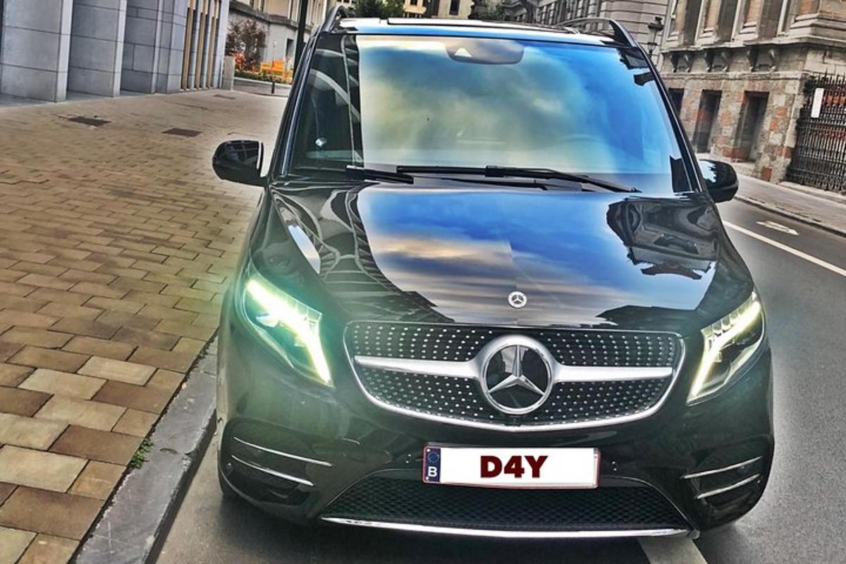 a green car parked on the side of a street