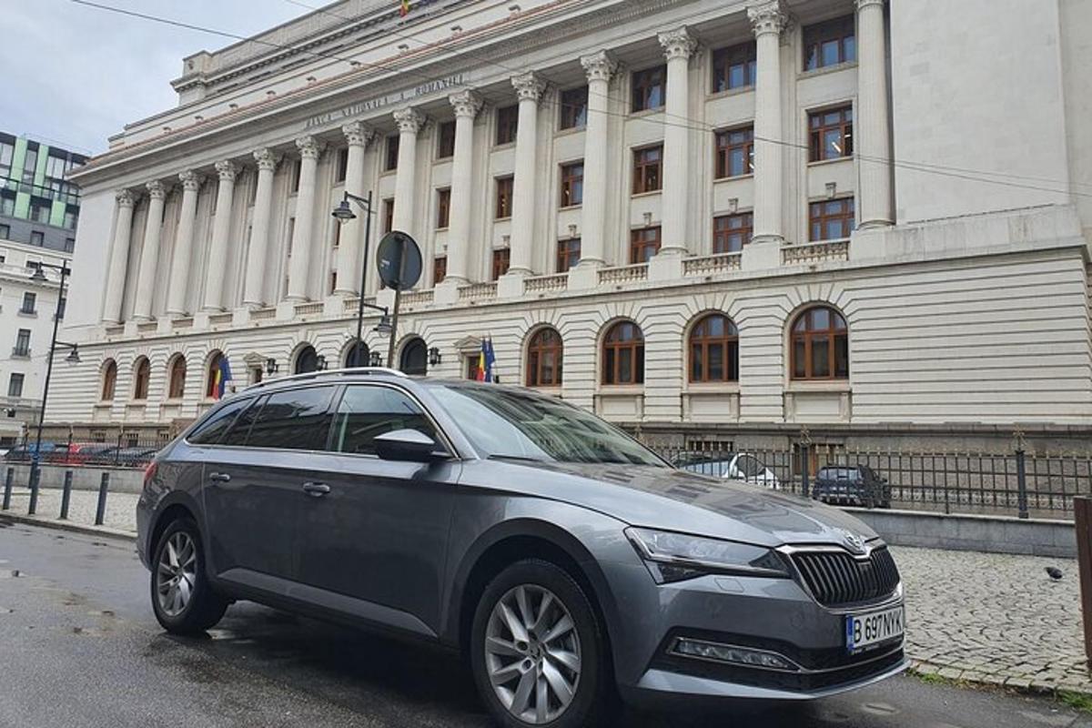 a silver car parked in front of a building