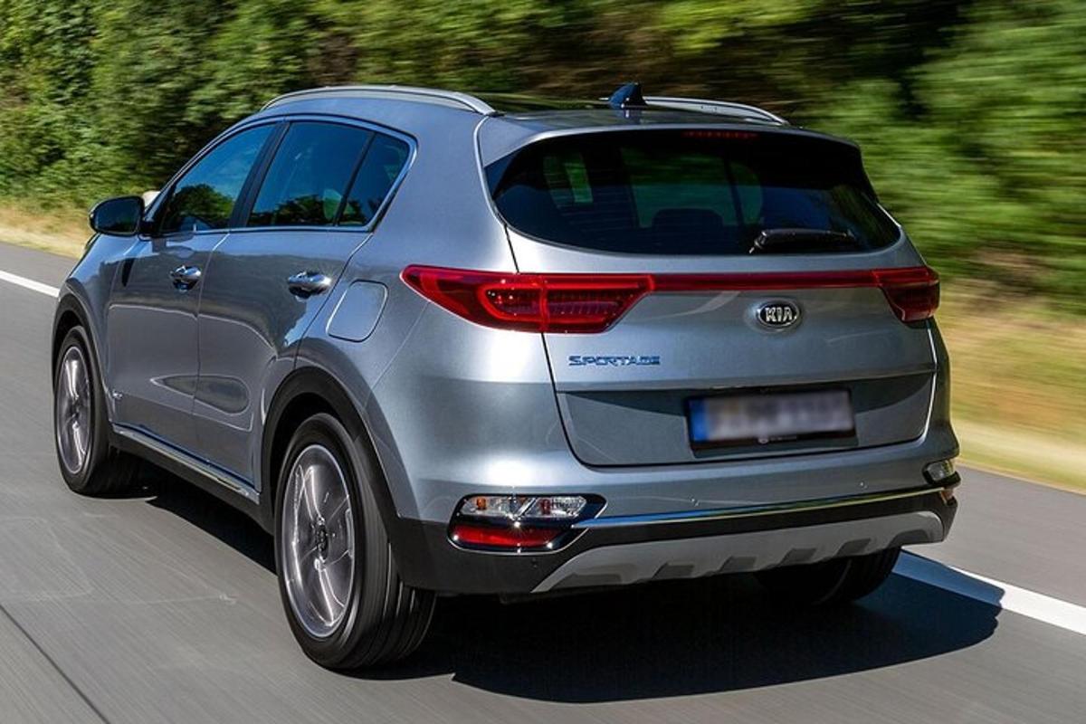 a silver car is driving down the road