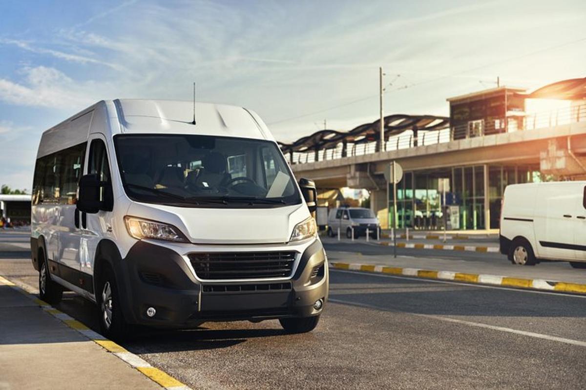 a white van is driving down a street