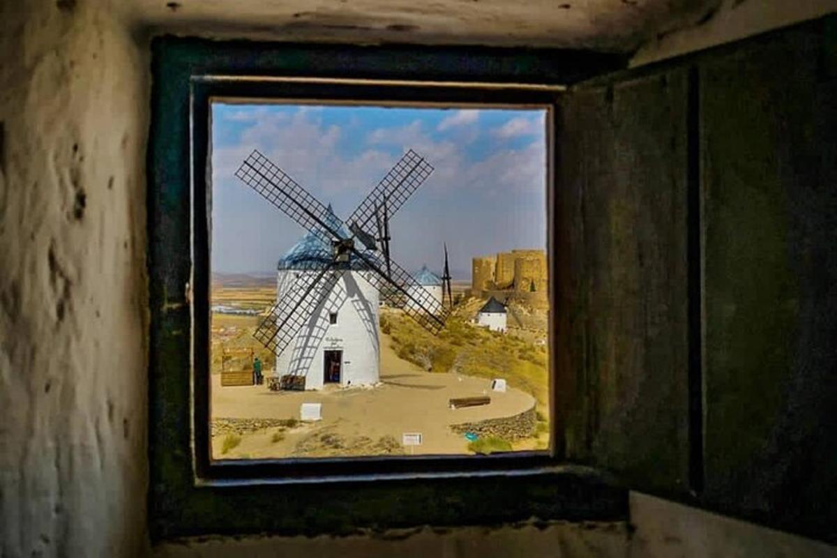 a window with a view of a windmill