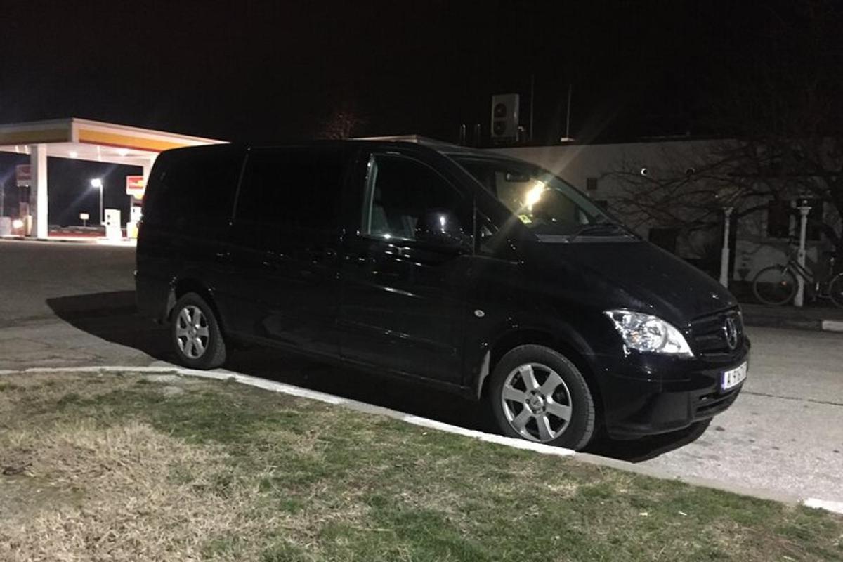 a black van parked in a parking lot at night