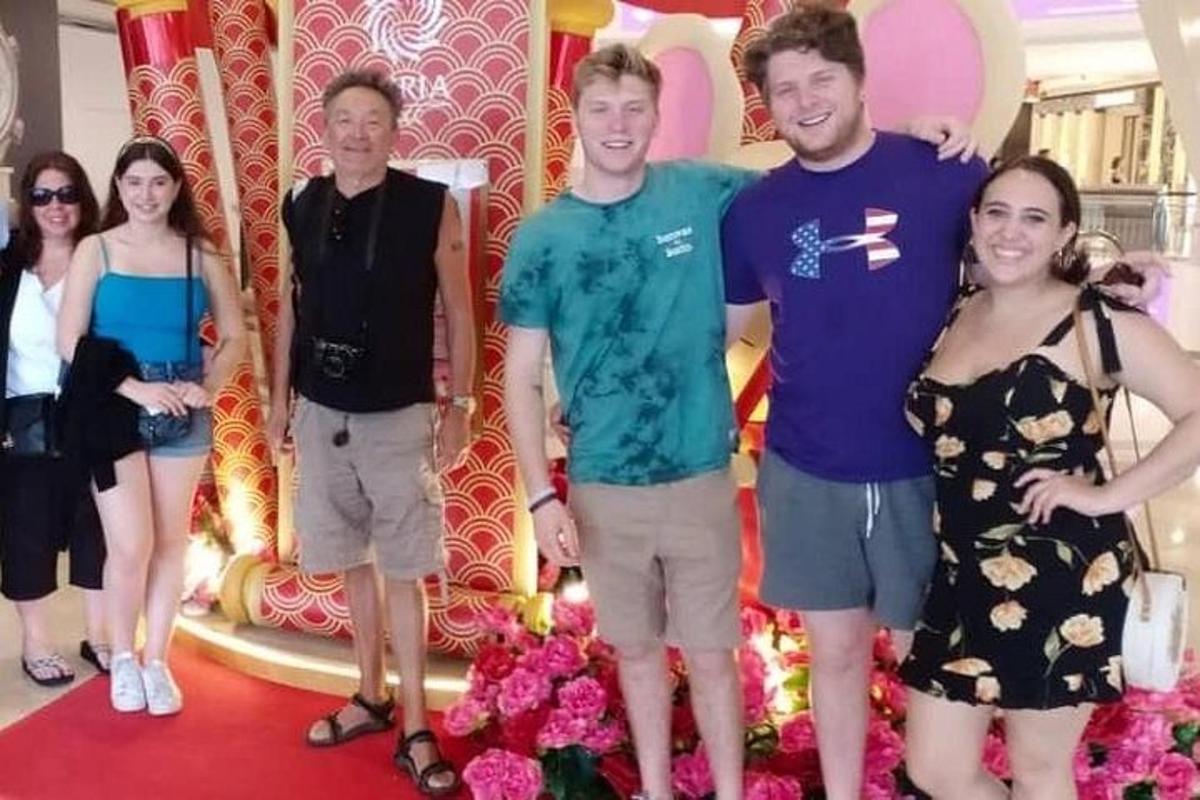 a group of people posing for a picture on a red carpet