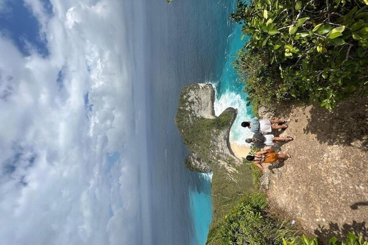 en gruppe mennesker som står på en klippe ved havet