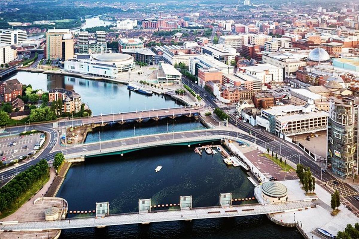 an aerial view of a city with a bridge over a river