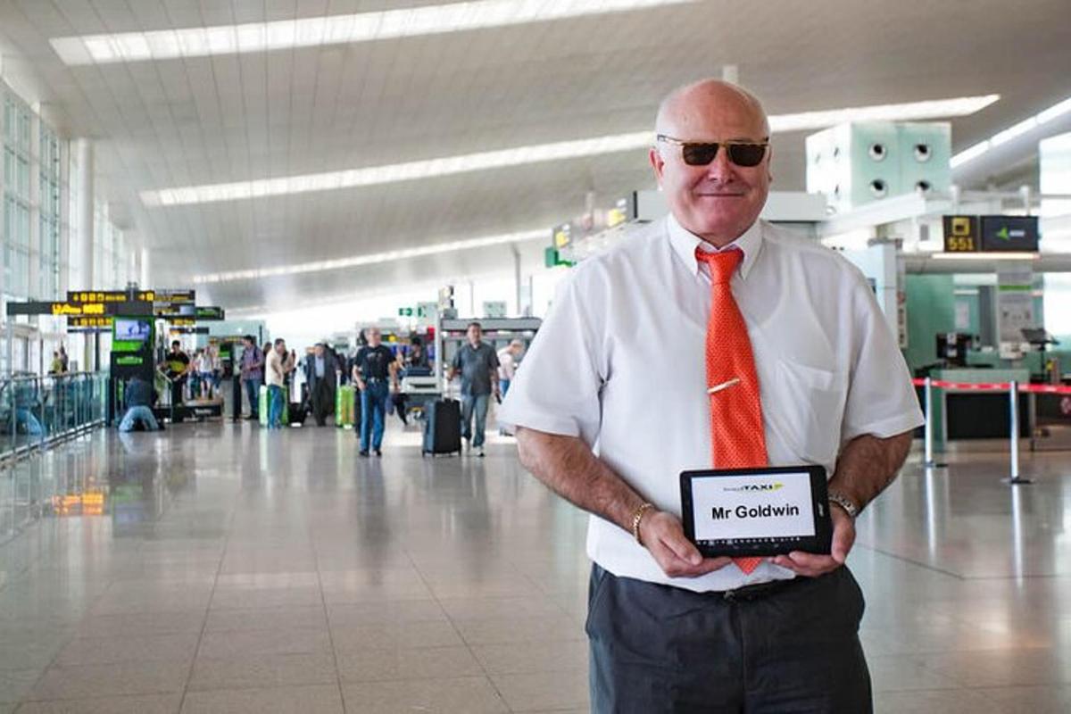 a man wearing a red tie holding a sign in an airport