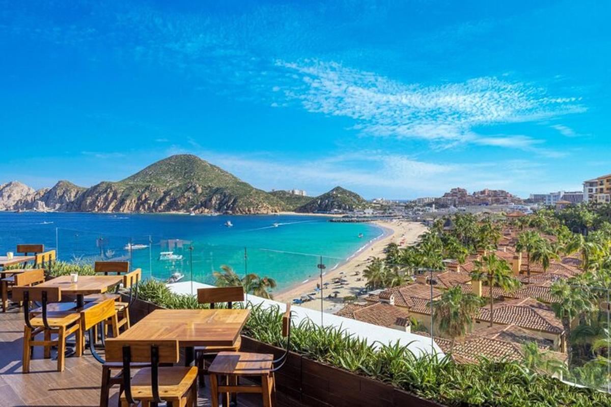 a view of the beach from a restaurant with tables and chairs