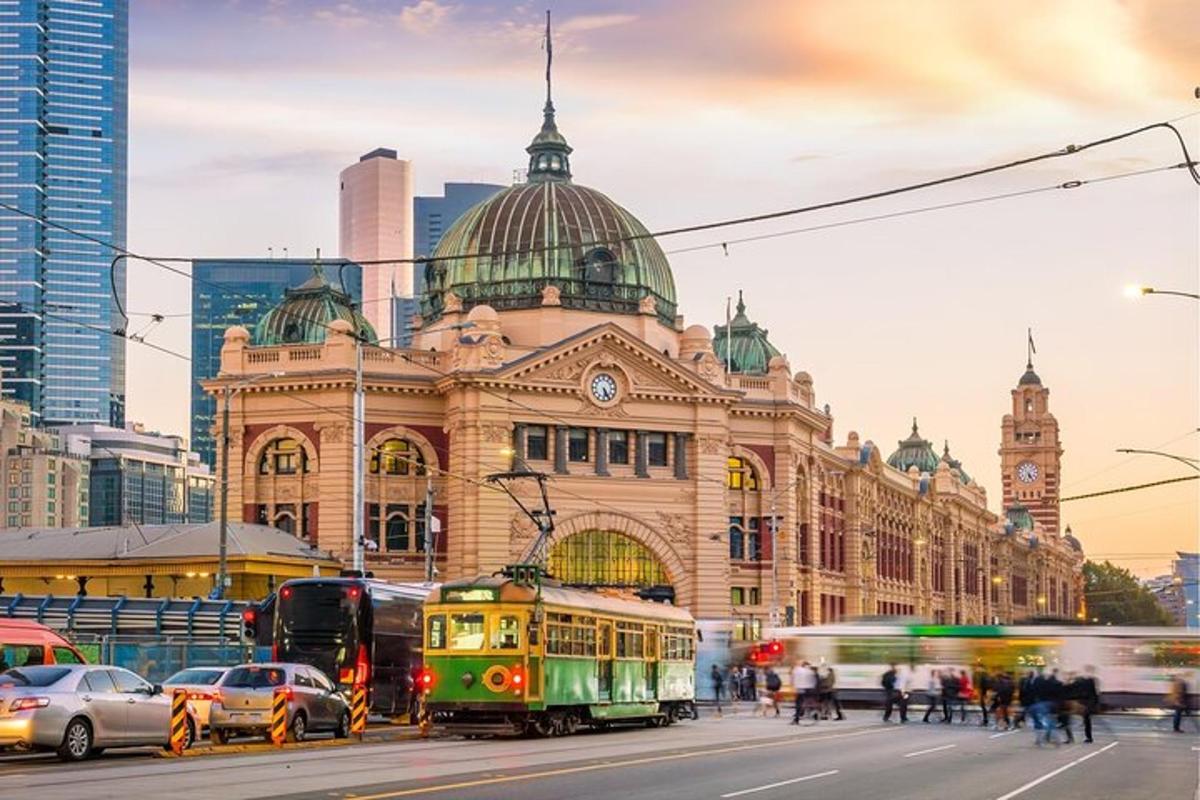 a tram in front of a building with a clock tower