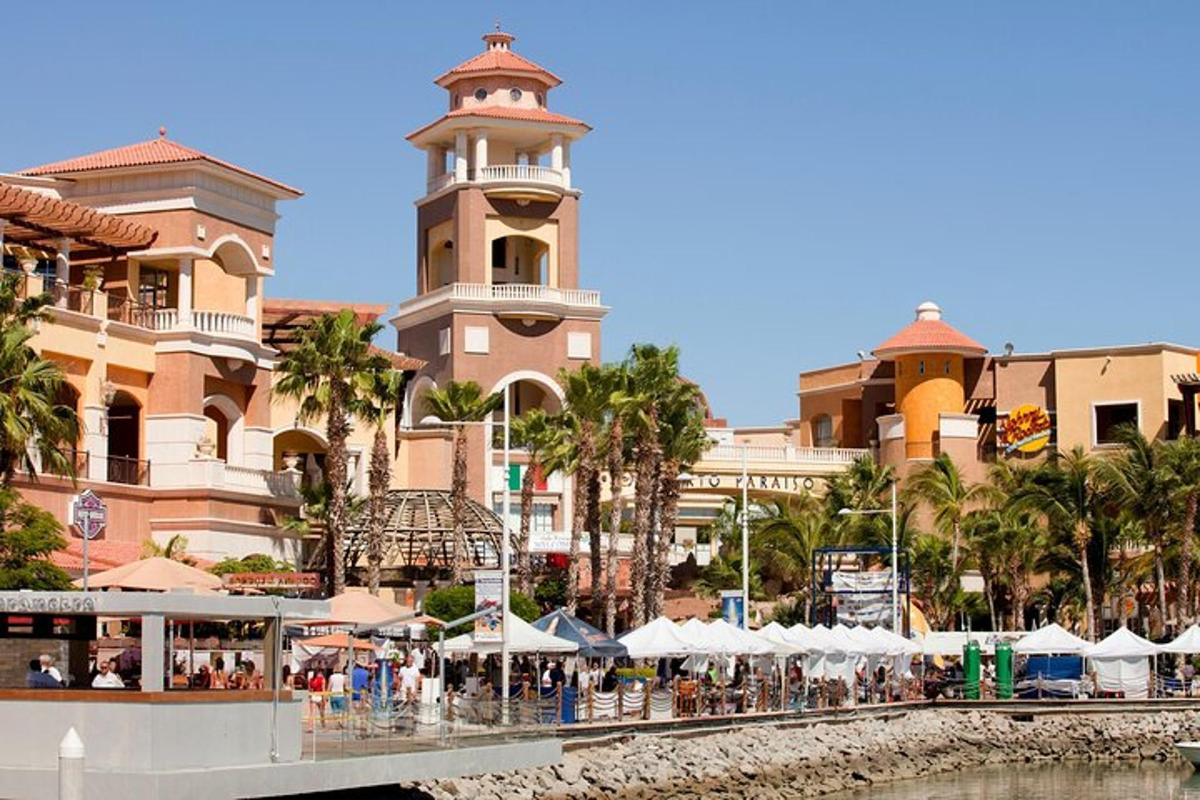 a building with a clock tower next to a body of water