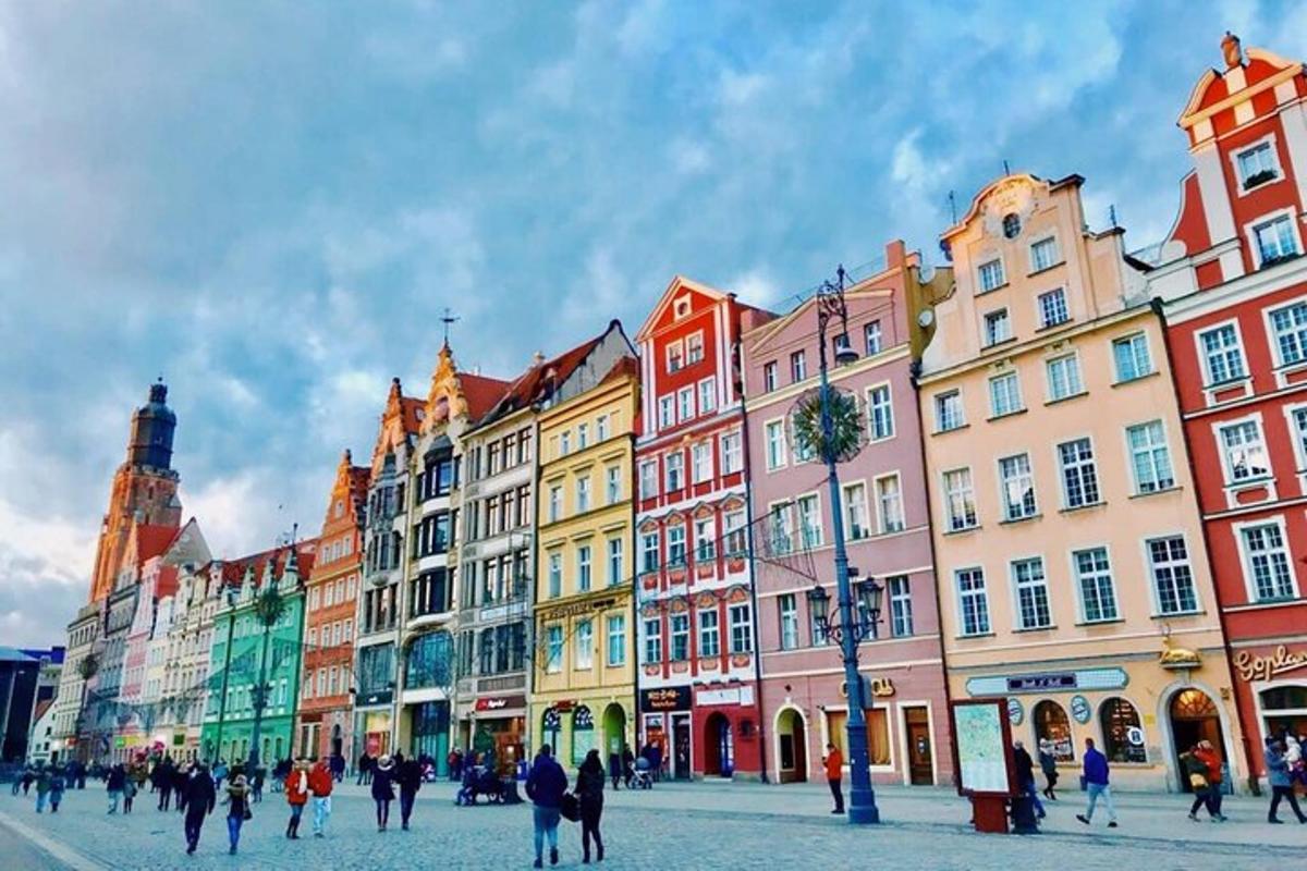 a group of people walking on a street with buildings