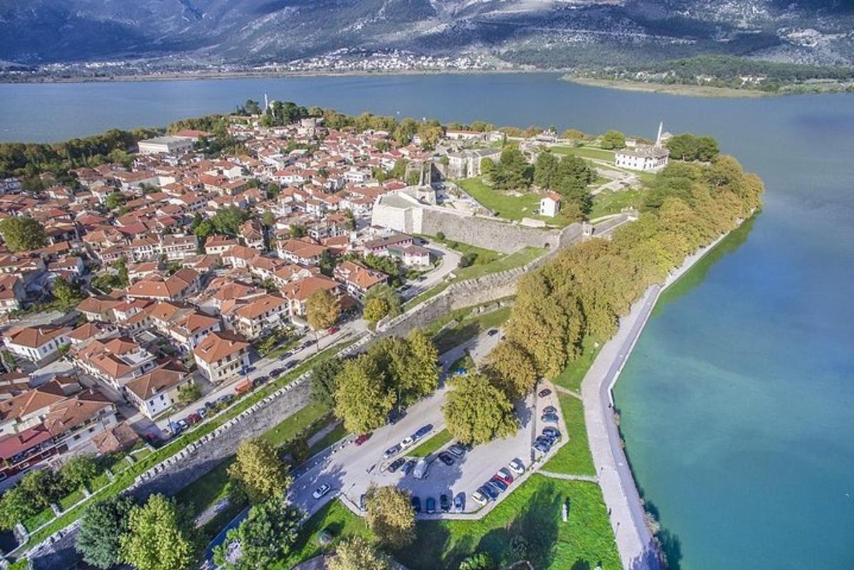 an aerial view of a town next to a body of water