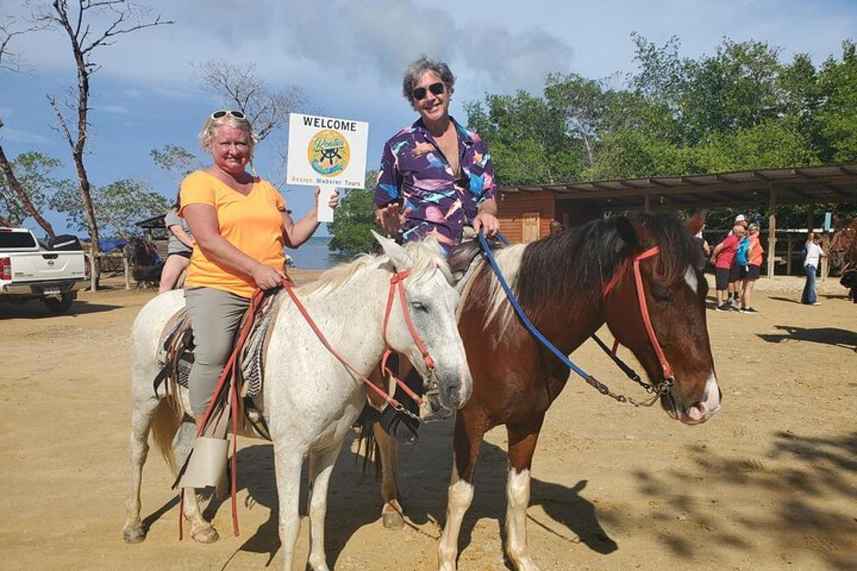 two women riding on a horse with a sign