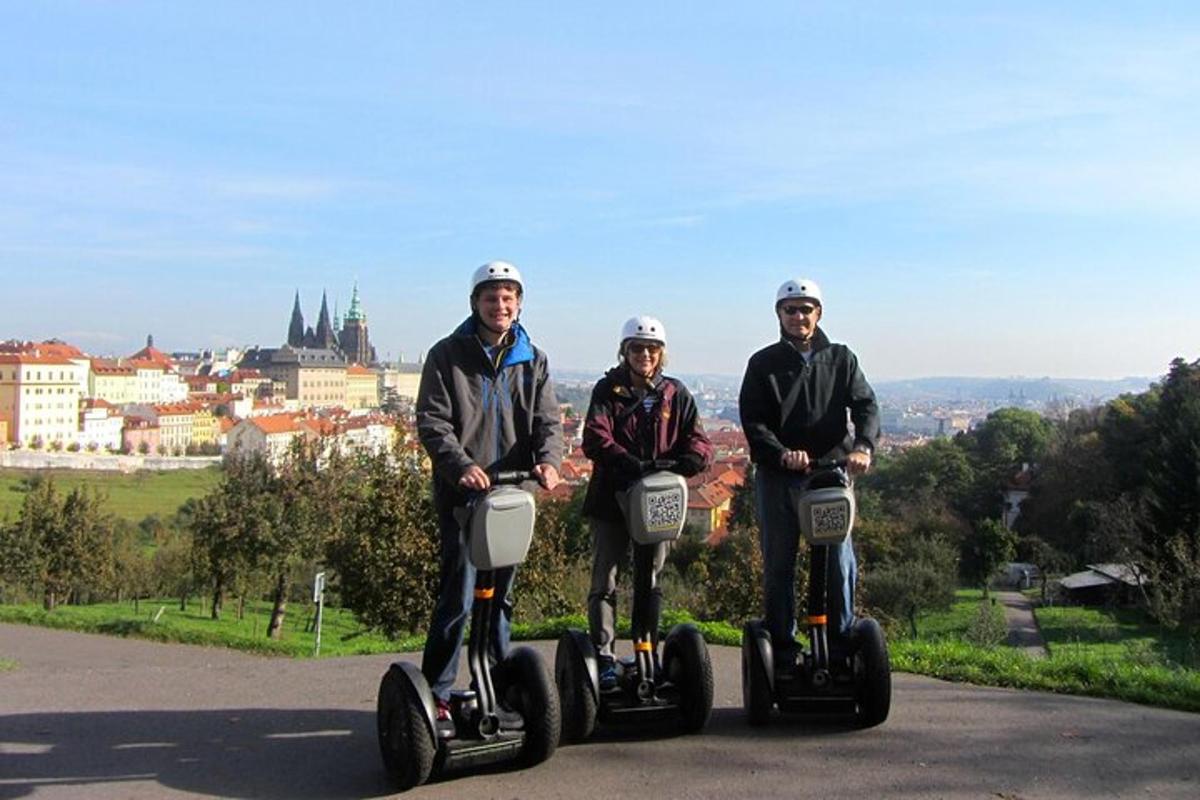 tři lidé jedoucí na segwayích po silnici