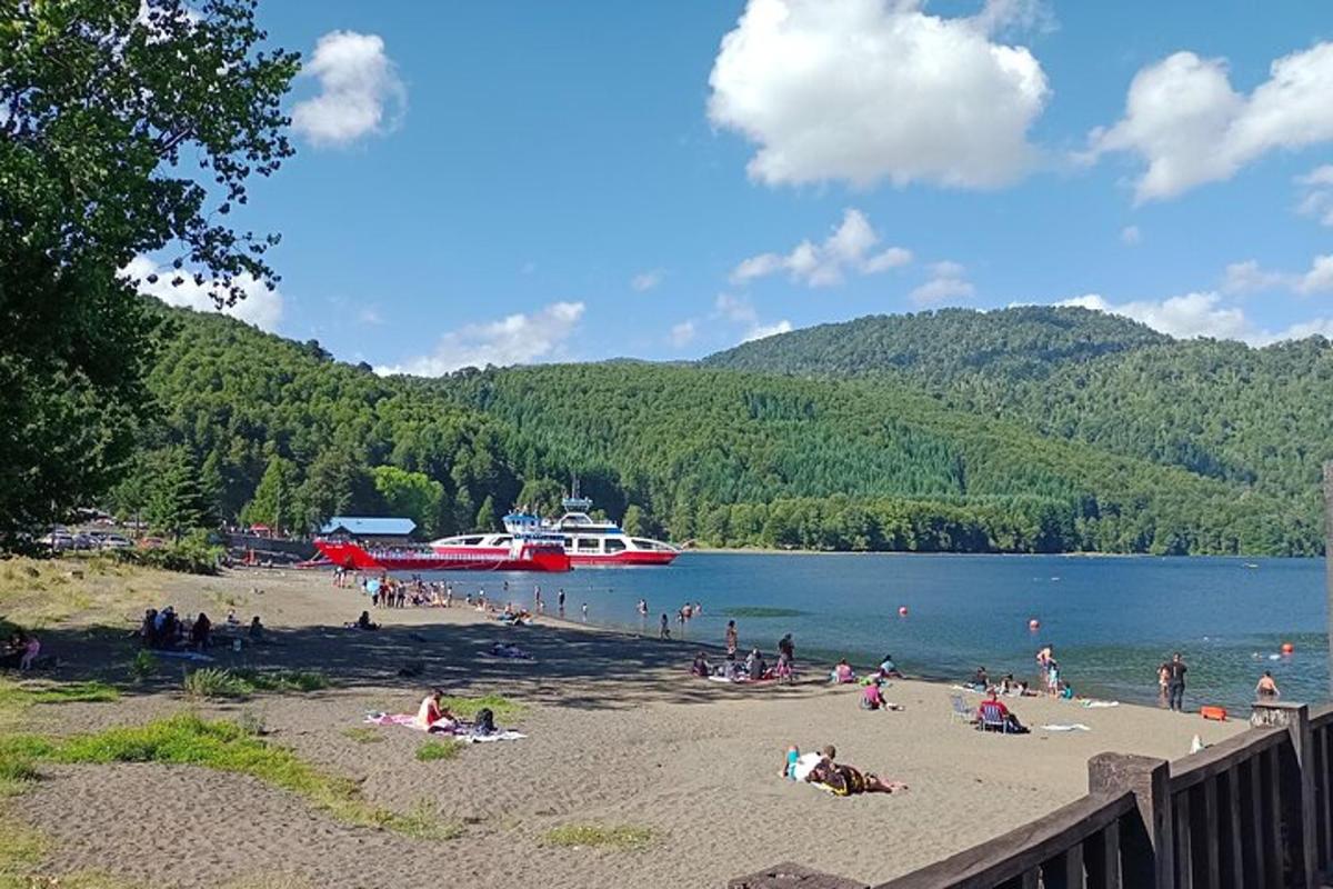 a group of people on a beach with a boat in the water