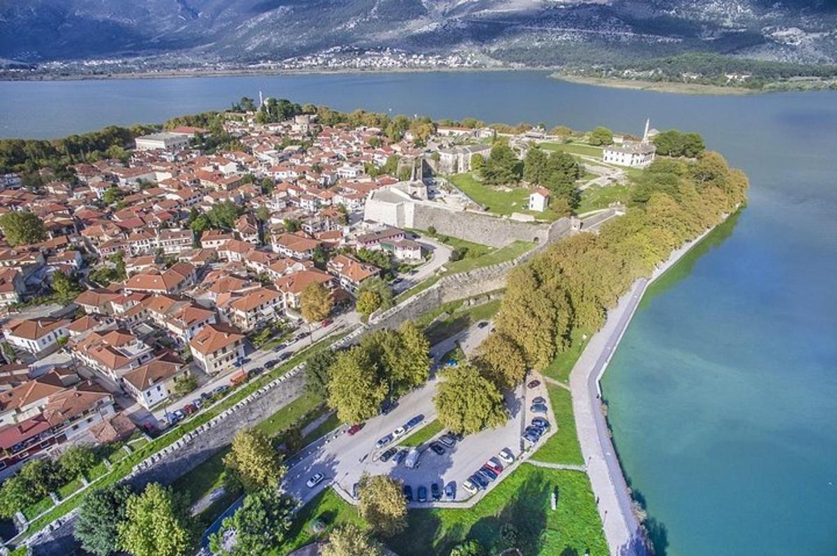 an aerial view of a town next to a body of water