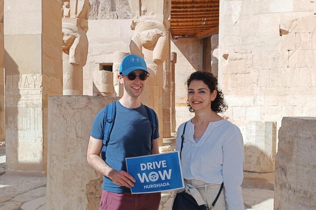 a man and a woman holding a sign that says drive new
