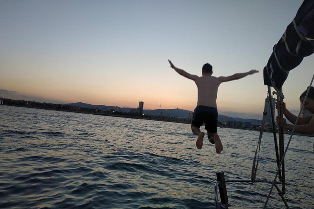 a man jumping into the water from a boat