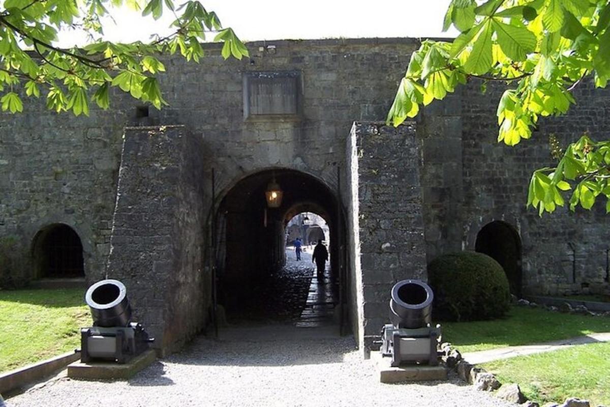 an entrance to a stone building with a tunnel