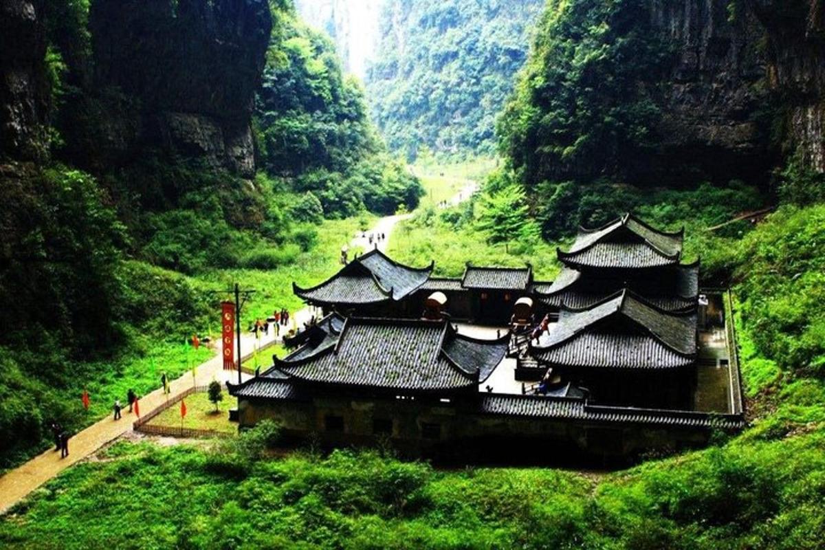 an asian style building on a hill in a valley