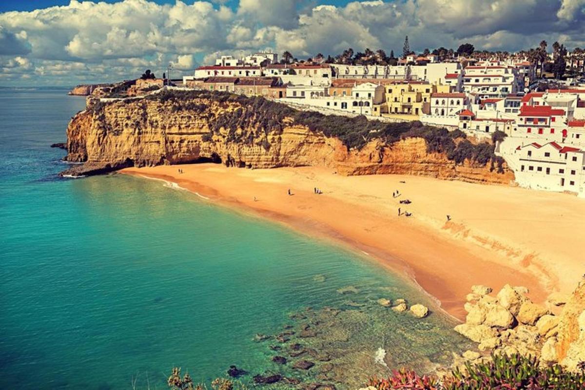 uma vista de uma praia com edifícios em um penhasco
