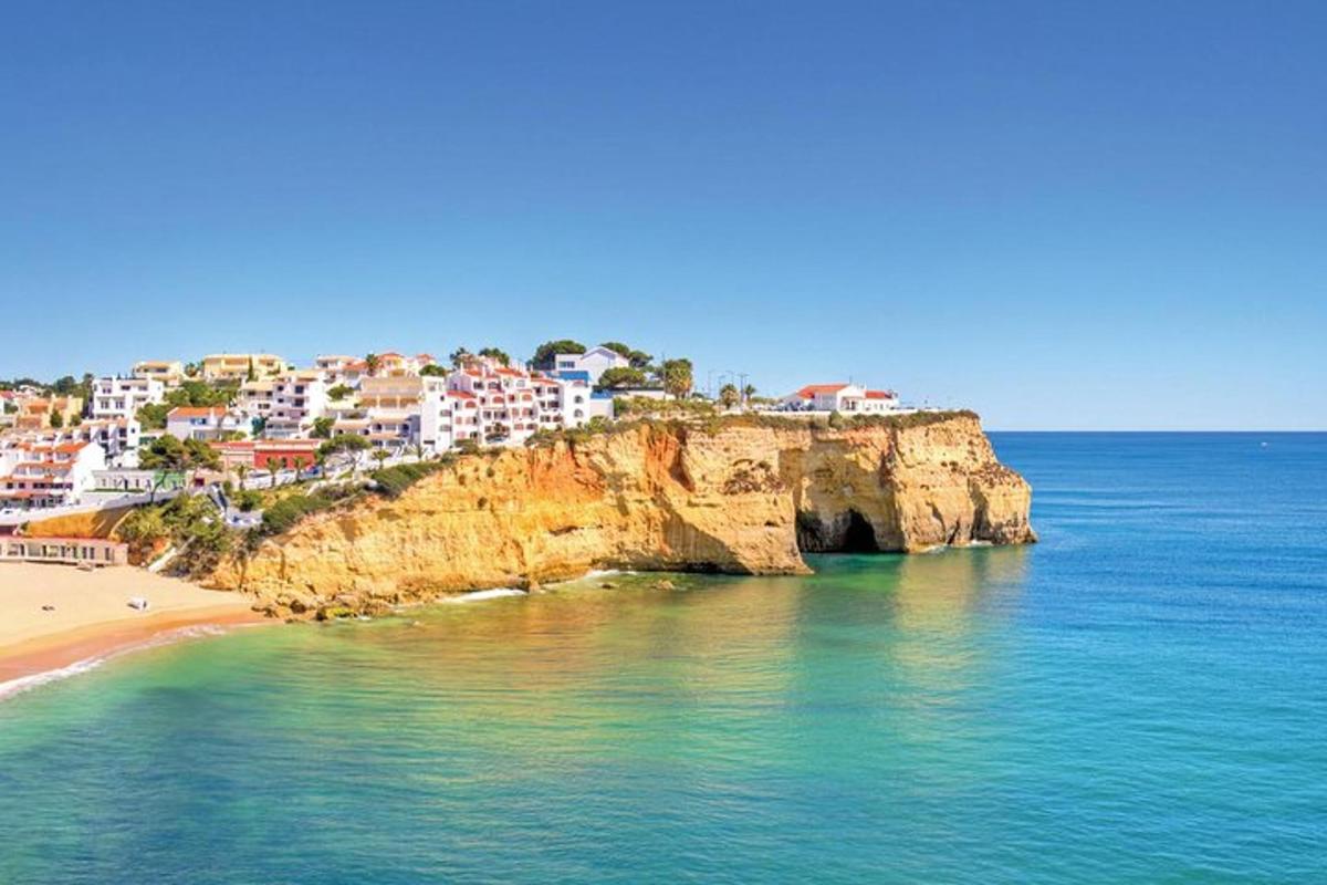 a view of a beach and a cliff with houses